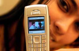A model displays an EDGE-enabled mobile handset which has the facility of playing/sending movie clips, a latest offering from Airtel in the country during a press meet in Mumbai on Thursday. 