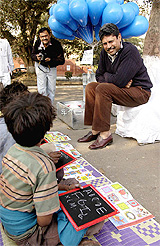 Former cricketer Kapil Dev spends time with underprivileged children residing around New Delhi railway station on Thursday