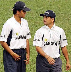 Sourav Ganguly, captain of the Indian cricket team, and Sachin Tendulkar talk during a practice session in Dhaka stadium on Thursday