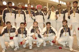 Members of the Indian Punjab volleyball team make the victory sign after defeating Pakistan Punjab during the first Indo-Pak Punjab Games at polo ground in Patiala on Friday.