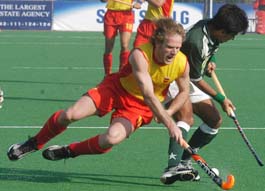 Spain�s David Alegre tries to snatch the ball from Pakistani captain Waseem Ahmed during their Champions Trophy hockey match at Lahore on Friday.