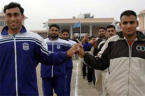 Kabbadi players from both sides hold hands as they enter the stadium during  the India-Pakistan Punjab Games in Patiala. 