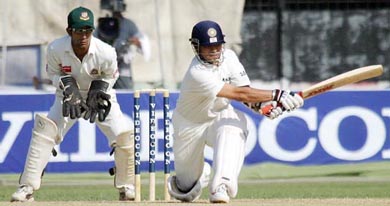 Sachin Tendulkar hits a boundary to complete his double century against Bangladesh during the third day of the first Test in Dhaka on on Sunday