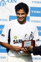 Irfan Pathan smiles with the Man of the Match trophy after Bangladesh lost the first Test in Dhaka on Monday. 