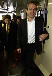 Juergen Klinsmann, coach of Germany's national soccer team stands in a public train on the team's transfer between terminals at Tokyo's Narita airport on Tuesday.