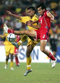 Thailand's Niweat Siriwong tussles for the ball