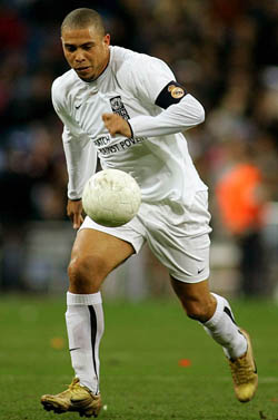 Brazilian star Ronaldo runs with the ball during a United Nations Development Program charity soccer match at the Santiago Bernabeu stadium in Madrid on Tuesday