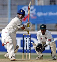 Sourav Ganguly plays a shot as Bangladesh wicketkeeper Khaled Mashud looks on during the second day of the second Test in Chittagong on Saturday. 