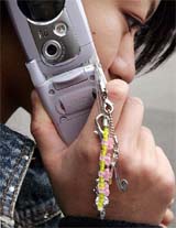 Fashion accessories dangle from a Japanese high school student�s mobile phone in Tokyo on Sunday. For the average Japanese teenager, a cell phone is a must-have item, used for email, taking photos and keeping track of dates, in addition to the simple phone call. 