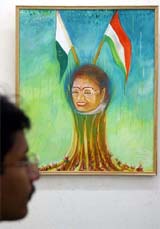 A visitor looks at a painting