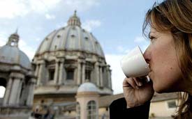 A tourist enjoys a cappuccino outside the rooftop coffee bar of Saint Peter�s Basilica at the Vatican on Monday. 