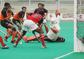BSF goalkeeper K.M. Subhayah successfully thwarts an attempt by Punjab Police players during their match in the All-India Ramesh Chander Memorial Hockey Tournament at Jalandhar on Monday. 