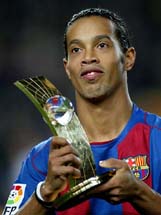 Soccer star Ronaldinho holds his trophy after he won FIFA�s World Player of the Year Award in Zurich.