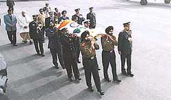Defence personnel carry the mortal remains of former Prime Minister P.V. Narasimha Rao at Palam Air Force Station in New Delhi on Friday before the body was flown to Hyderabad for cremation.