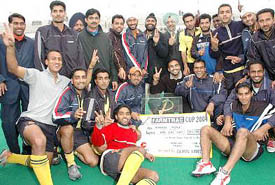 Members of the Punjab & Sind Bank team in a jubilant mood after winning the All-India Ramesh Chander Hockey Tournament in Jalandhar on Friday
