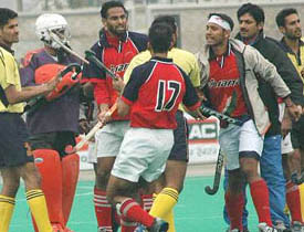 Players of Punjab Police and Punjab & Sind Bank clash during the final of the All-India Ramesh Chander Hockey Tournament in Jalandhar