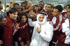 Members of the Qatar team celebrate after winning the 17th Arabian Gulf Cup Soccer Championship at Al-Sadd Stadium in Doha, Qatar