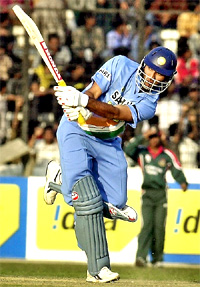 Yuvraj Singh hits a boundary off Bangladesh's Mashrafe bin Mortaza during the third one-day international in Dhaka