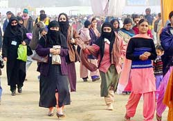 Ahmadiyya Muslim women proceeding to attend prayers in women’s enclosure at the 113th annual conference of Ahmadiyyas in Qadian on Tuesday.