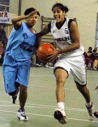 Punjab and Delhi cagers in action during their quarterfinal tie in the 55th Dhanoa Senior National Basketball Championship at Ludhiana