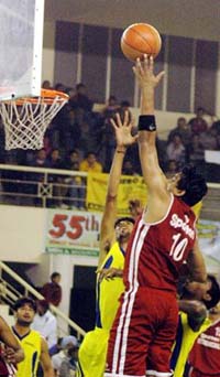 Nishant Kumar of Uttaranchal jumps to put the ball into the net during a semifinal against Indian Railways in the Dhanoa Senior National Basketball Championship in Ludhiana on Saturday. 