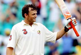 Australia's Adam Gilchrist celebrates reaching his century during the third day's play in the third Test against Pakistan in Sydney