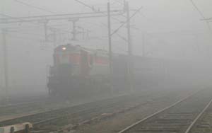Thick fog engulfs the railway track at Amritsar on Friday. Fog hung over the city, disrupting air and rail services for several hours. 