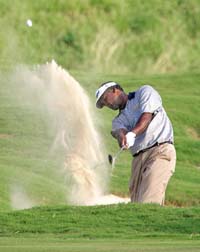 Vijay Singh, of Figi, hits out of the sand trap on the 18th green during the Mercedes Championships in Maui, Hawaii Thursday