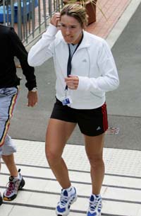 Defending Australian Open champion Belgium's Justine Henin-Hardenne walks to a press conference where she announced her withdrawal from the first Grand Slam of the year in Sydney, Australia, on Saturday