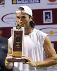 Carlos Moya of Spain hold the trophy after beating Paradorn Srichaphan of Thailand in the final