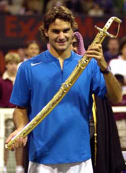 Roger Federer of Switzerland shows the sword presented to him after he beat Croatia�s Ivan Ljubicic