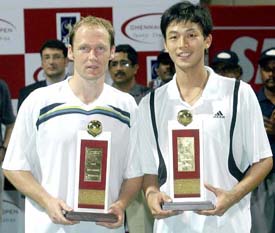 Yen-Hsun Lu  of Taipei and Rainer Schuettler of Germany hold the trophy after winning the Chennai Open doubles title on Sunday
