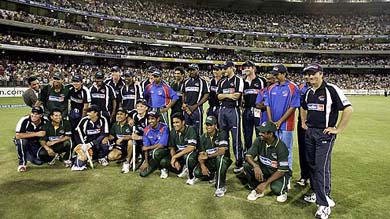 Members of the Asia XI and World XI teams pose in front of the Great Southern Stand after the tsunami fund-raising match in Melbourne