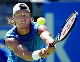 Lleyton Hewitt of Australia returns to Karol Beck of Slovakia during their match at the Sydney International tennis tournament in Sydney on Tuesday