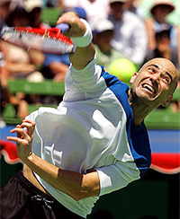 Andre Agassi of the USA serves during his match against Nicolas Massu of Chile at the Kooyong Classic tennis tournament in Melbourne on Wednesday