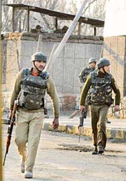 Central Reserve Police personnel rush to the sports stadium during an encounter in Srinagar