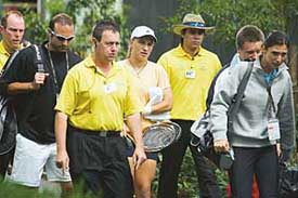 Russia�s Svetlana Kuznetsova is escorted by security personnel along with compatriot Anastasia Myskina