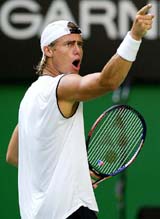 Australia's Lleyton Hewitt points to a member of his family after winning the third set during his second round match against James Blake