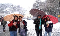 Girls from Chandigarh enjoy the fresh snowfall on the Ridge maidan in Shimla on Friday.