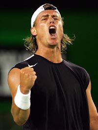 Australia's Lleyton Hewitt reacts after making a shot against Argentina's Juan Ignacio Chela at the Australian Open tennis tournament in Melbourne on Saturday