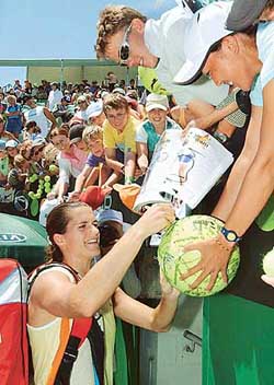 Amelie Mauresmo of France signs autographs for fans after her fourth round victory over Evgenia Linetskaya of Russia at the Australian Open in Melbourne on Sunday