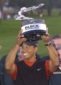 Tiger Woods holds up his trophy after winning the Buick Invitational in San Diego on Sunday