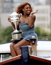 Serena Williams of the USA, winner of the women�s singles title at the Australian Open, poses with the trophy on a water taxi in the Yarra river in Melbourne