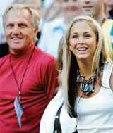 Bec Cartright, girlfriend of Australia's Lleyton Hewitt, stands next to Australian golfer Greg Norman before the start of the men's singles final at the Australian Open tennis championship