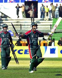 Bangladesh captain Habibul Bashar, right, reacts after hitting the winning shot, as teammate Aftab Ahmed looks on 