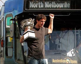 Russia's Marat Safin takes a tram ride while holding the Australian Open trophy in Melbourne on Monday