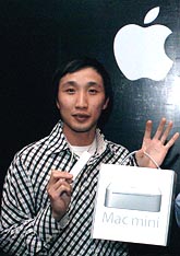 Apple product Marketing Manager, Asia Pacific, Darren Sng holds a pair of 'Mac Mini', during a launch presentation in New Delhi 