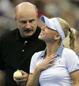 Anna Kournikova talks with her doubles partner