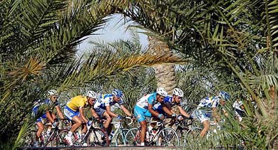 Quick Step team rider Tom Boonen of Belgium cycles in the pack past palm trees during the 167.5-km second stage