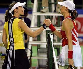 Former world number one Martina Hingis of Switzerland congratulates Germany's Marlene Weingartner at the net after their first round match at the Volvo Women's Open in Pattaya